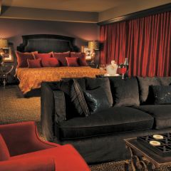 Seating Area And Bed In Houston Suite