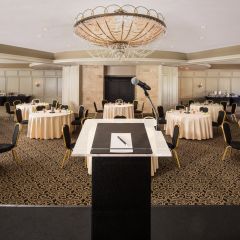 Ballroom With Round Tables and Podium 