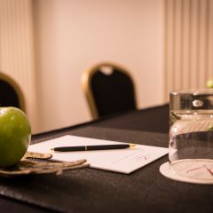 Apple and Water On Meeting Table